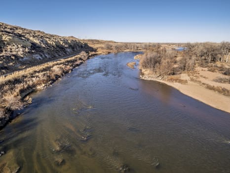 aerial view of South Platte River at Wildcat Mound in eastern Colorado below Platteville, a typical winter scenery with exposed sandbars and rock garden