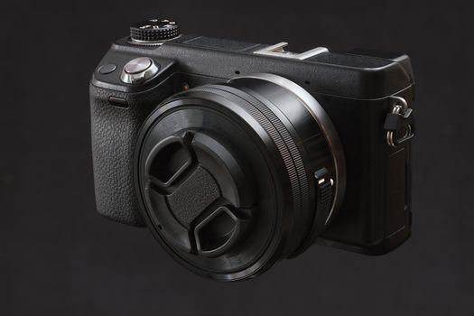 black mirrorless camera on a black background