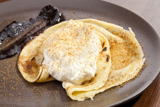 Crepe pancake with whipped cram and gingerbread powder