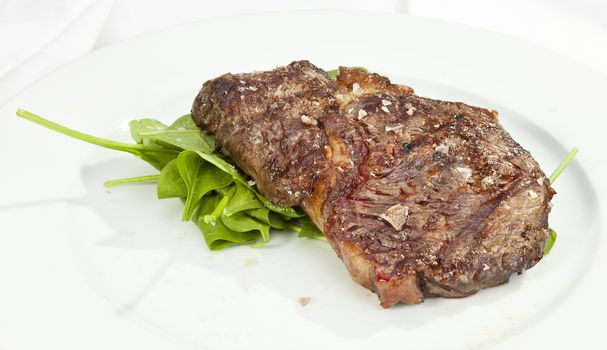 Grilled Sirloin steak with spinach and coarse salt