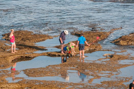 MOSSELBAY, SOUTH AFRICA - JANUARY 1, 2015: Unidentified people late afternoon at the Reebok beach