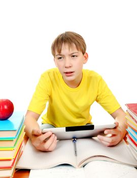 Tired Kid with Tablet Computer at the Desk with the Books on the White Background