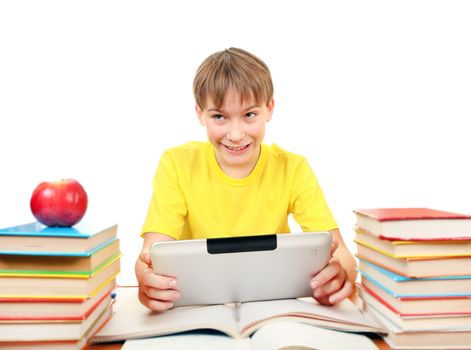 Cheerful Kid with Tablet Computer at the Desk with the Books on the White Background