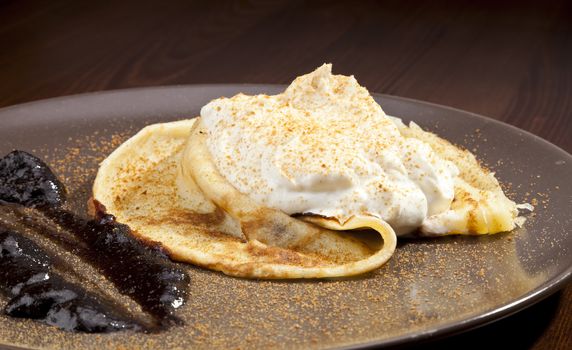 Crepe pancake with whipped cram and gingerbread powder