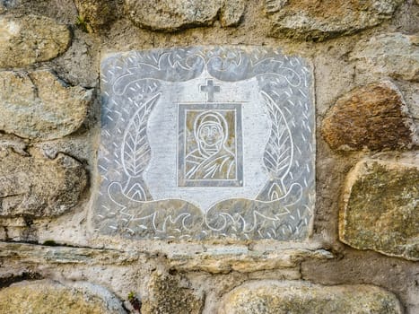 Ancient Greek Virgin Mary picture on the stone wall. Background