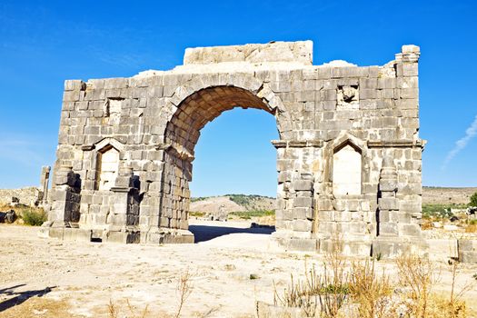 Old gate at Volubilis in Morocco. Volubilis is a partly excavated Roman city in Morocco situated near Meknes between Fes and Rabat. It was developed from the 3rd century BC onwards as a Phoenician Carthaginian settlement