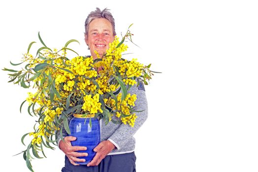  Beautiful mature woman with a bouquet of mimosa