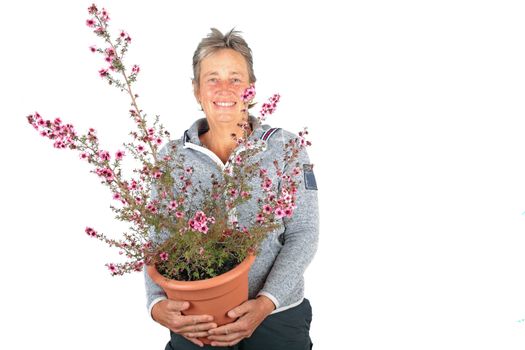 Beautiful mature woman with a beautiful blossoming plant