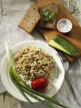 Tasty and healthy buckwheat dish with bread, onion, cucumber