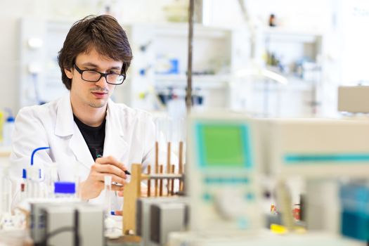 Male researcher carrying out scientific research in a lab (shallow DOF; color toned image)