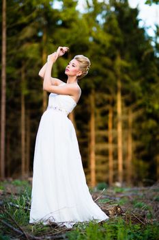 Lovely bride outdoors in a forest