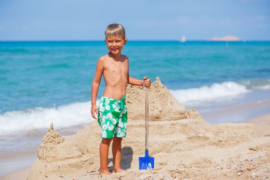 Young boy playing in the sand on the beach