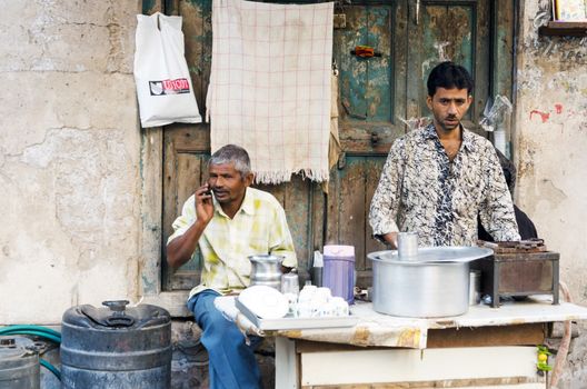 Ahmedabad, India - December 28, 2014: Unidentified Indian man selling tea at street in Ahmedabad, India. Ahmedabad is the largest city and former capital of the western Indian state of Gujarat.