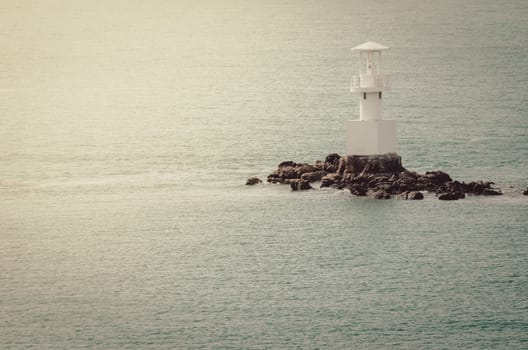 White Lighthouse on the sea and blue sky in Thailand vintage