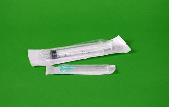 piccture of single medical medical syringe on color backgrouund