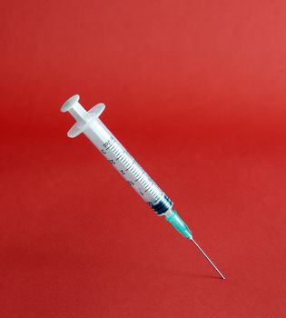 piccture of single medical medical syringe on color backgrouund