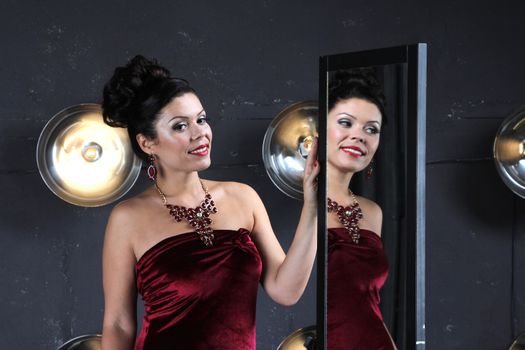 Lady in red and magic mirror on stage