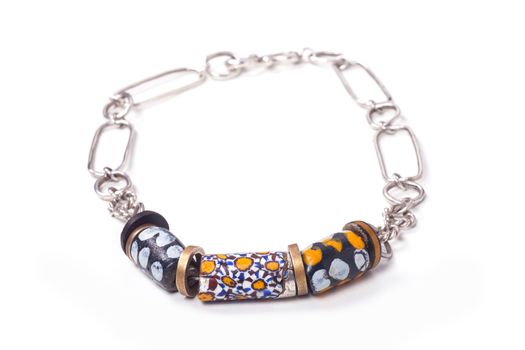 Close up of silver and painted stone necklace isolated on white background, manufactured by Ornella Salamone