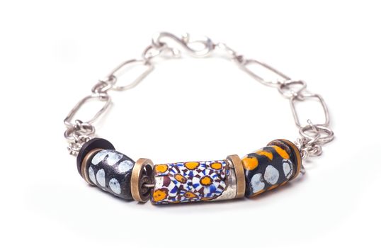 Close up of silver and painted stone necklace isolated on white background, manufactured by Ornella Salamone