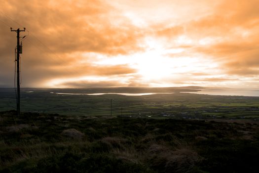 view of the Kerry coast with telegraph masts going into the countryside