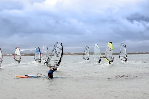 wind surfers braving the storm winds on the wild atlantic way in county Kerry Ireland