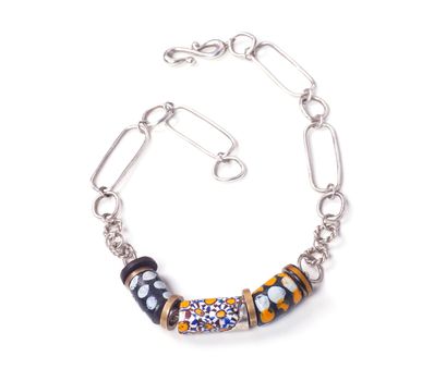 Close up of silver and painted stone necklace isolated on white background, manufactured by Ornella Salamone