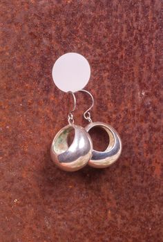 Close up of silver earrings, manufactured by Ornella Salamone