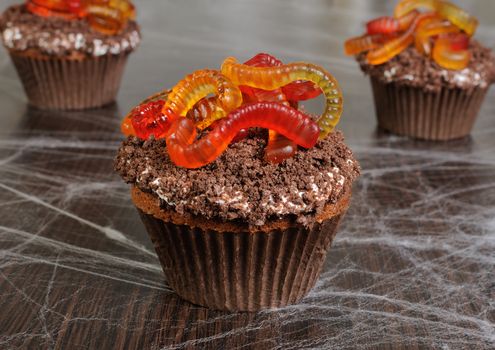 Muffin with cream in wafer crumbs and jelly worms