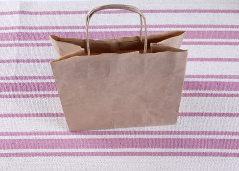 Brown paper shopping bag on a beautiful background.