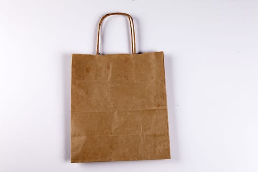 Brown paper shopping bag on a beautiful background.