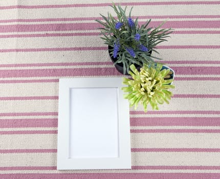 Beautiful composition with photo frames and flowers on a background of rustic rug.