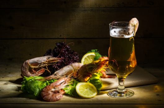 still life with beer, shrimp and fresh herbs