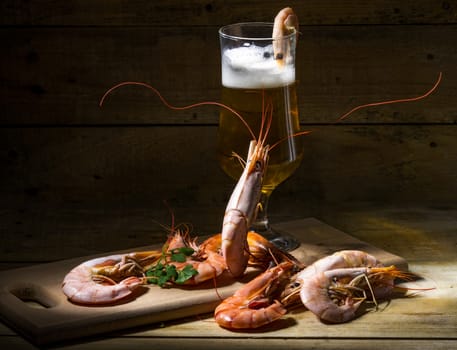 still life with beer, shrimp and fresh herbs
