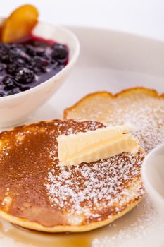 tasty sweet pancakes with vanilla icecream fruit jam and syrup topping