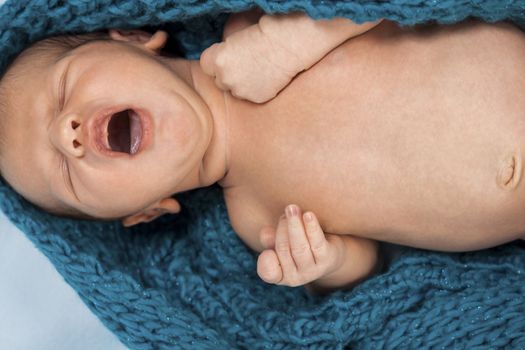 Close up Cute White New Born Baby Lying in Prone on White Cotton Cloth with Open Mouth