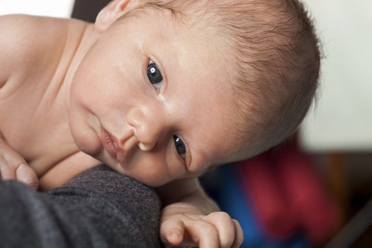 Close up Cute White New Born Baby Lying in Prone on White Cotton Cloth with Open Mouth