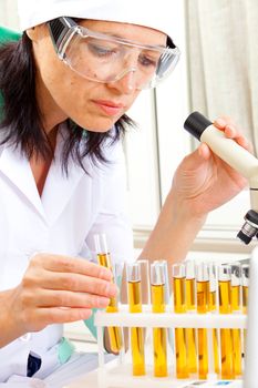 female scientist microscoping in the life science research laboratory (genetics, biochemistry, forensics, microbiology) 
