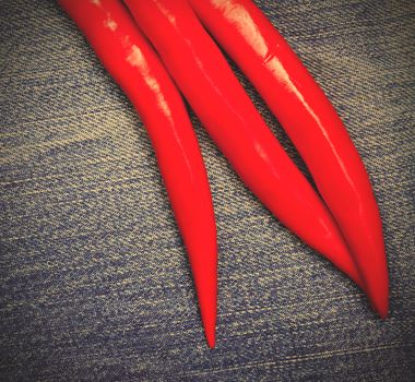 red hot chili pepper on jeans background, close up. instagram image style