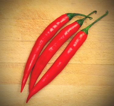red hot chili peppers on the wooden background. instagram image style