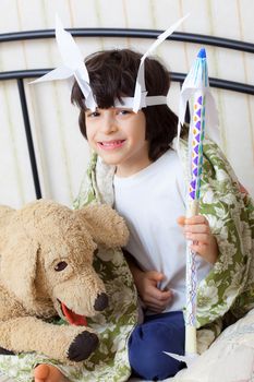 smiling boy in the American Indian image with spear in hand