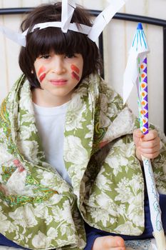 boy playing with a spear in his hand in the image of the American Indian