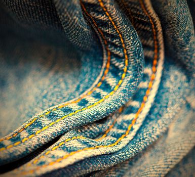 old Jeans with yellow stitching thread, close up. small depth sharpness. instagram image retro style