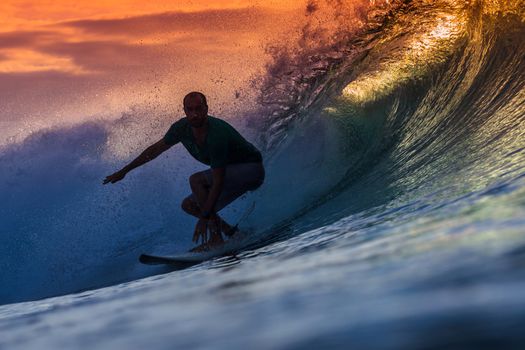 Surfer on Amazing Wave at sunset time, Bali island.