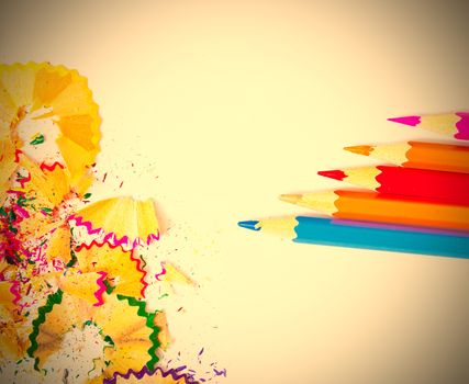 colored pencils and shavings on white background with copy space. instagram image retro style