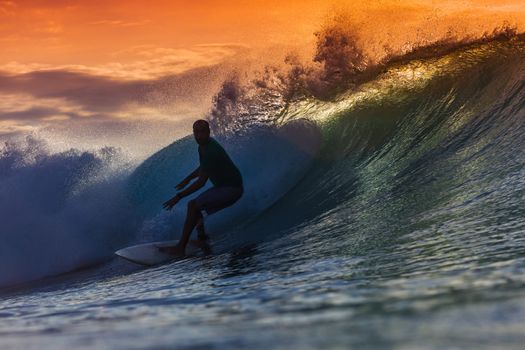 Surfer on Amazing Wave at sunset time, Bali island.