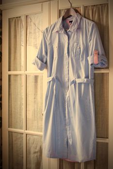 cotton summer dress on a hanger on the door wardrobes