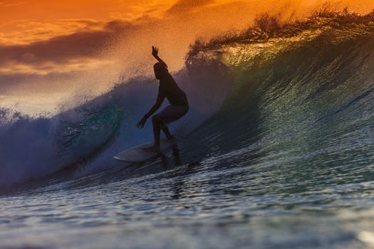 Surfer on Amazing Wave at sunset time, Bali island.