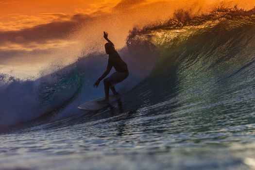 Surfer on Amazing Wave at sunset time, Bali island.