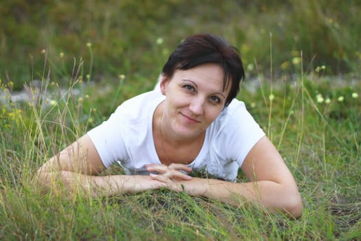 Woman laying in the grass on the meadow