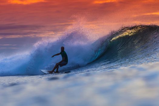 Surfer on Amazing Wave at sunset time, Bali island.